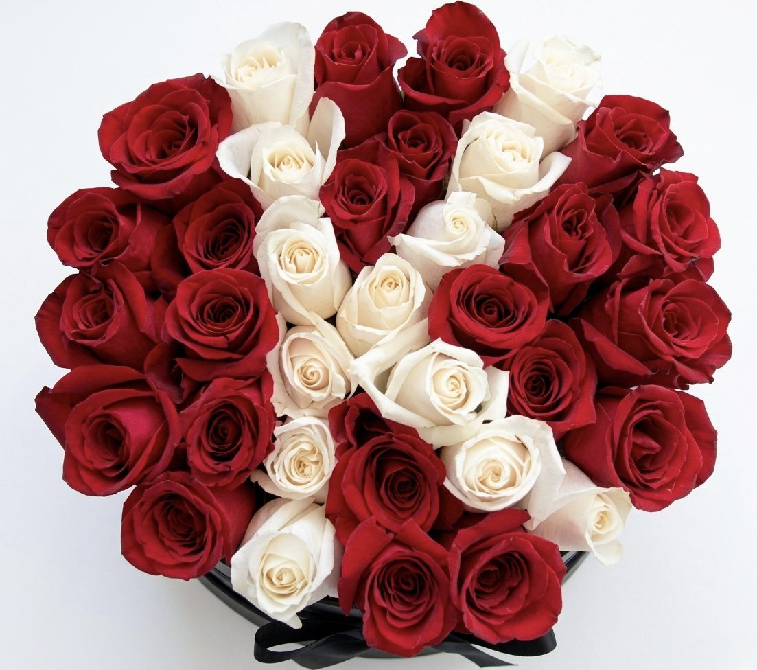The FLEUR Collection #163 from Orange County Flowers features densely packed red and white roses arranged in a circular pattern, shown from above on a plain white background.