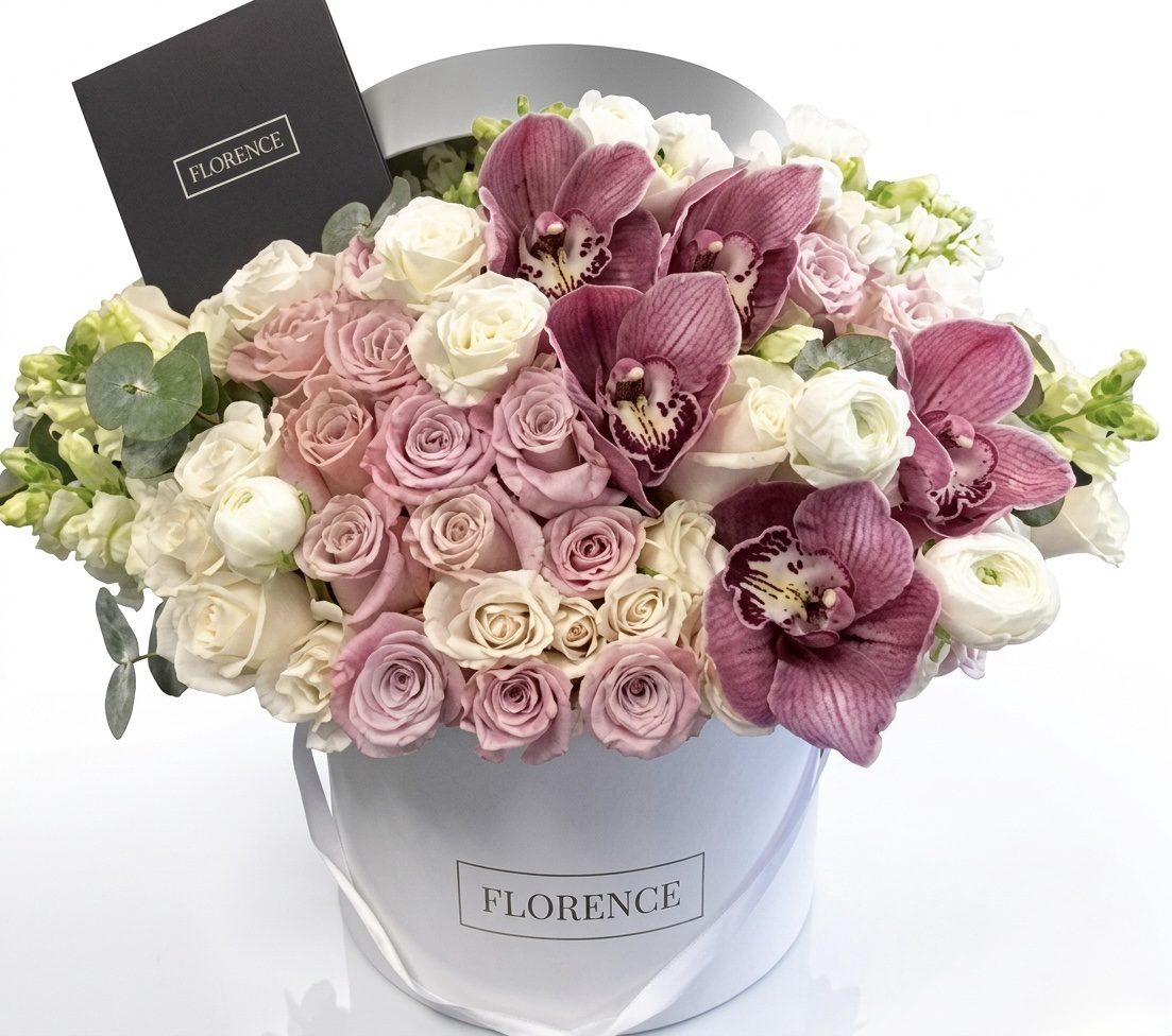 The FLEUR Collection #89 features a white hat box by Orange County Flowers, filled with light pink and white roses, ranunculus, eucalyptus, purple orchids, and includes a black Florence card.