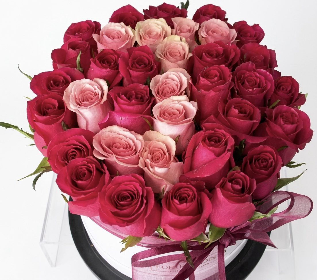 The FLEUR Collection #87 features a round bouquet of dark pink roses around the edge and pale pink roses in the center, beautifully arranged in a white box with a pink ribbon—expertly crafted by Orange County Flowers.