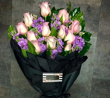 Flower arrangment made in Westminster, CA, Orange County, by Bolsa Florist, product is called Budding Romance - Wrapped Bouquet