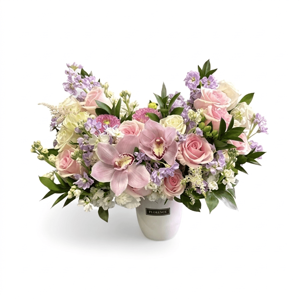 The Aurora Bloom - Ceramic Vase showcases a bouquet of pink orchids, pale pink and cream roses, light purple flowers, and green leaves, arranged beautifully against a white background.